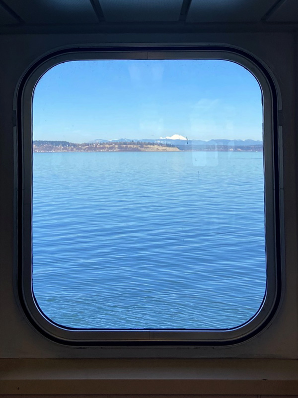 ferry window with water and mountain in background