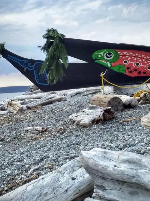 Pictures of two beautiful canoes resting on the shore