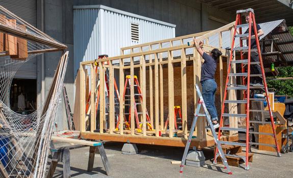 salvage wood storage shed under construction 