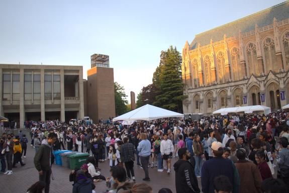 UW red square with lots of people and tents for TSA night market