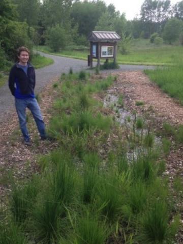 Person smiling next to prairie grasses