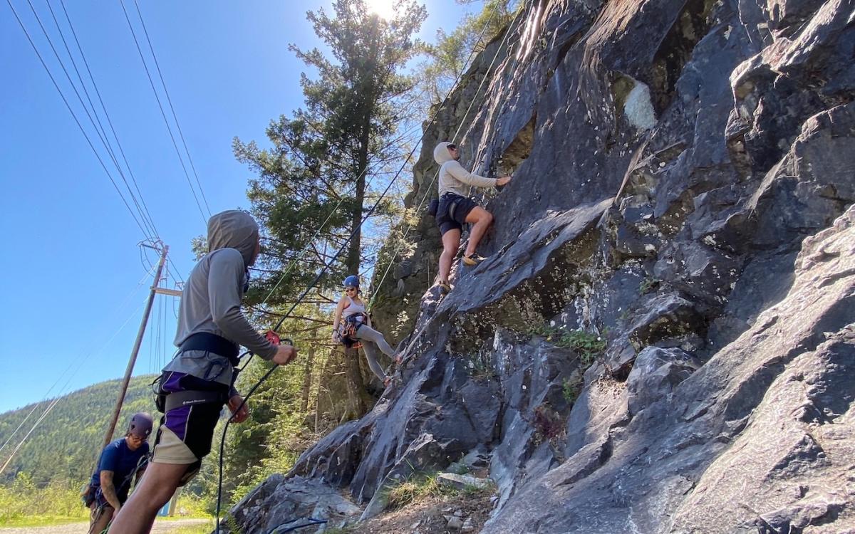 Students climbing outdoor boulder 