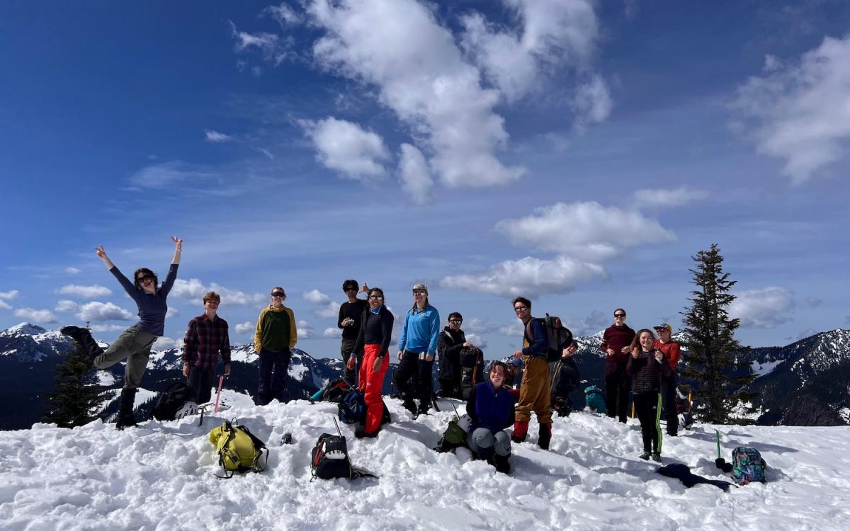 Group of students with snow with backpacks and gear