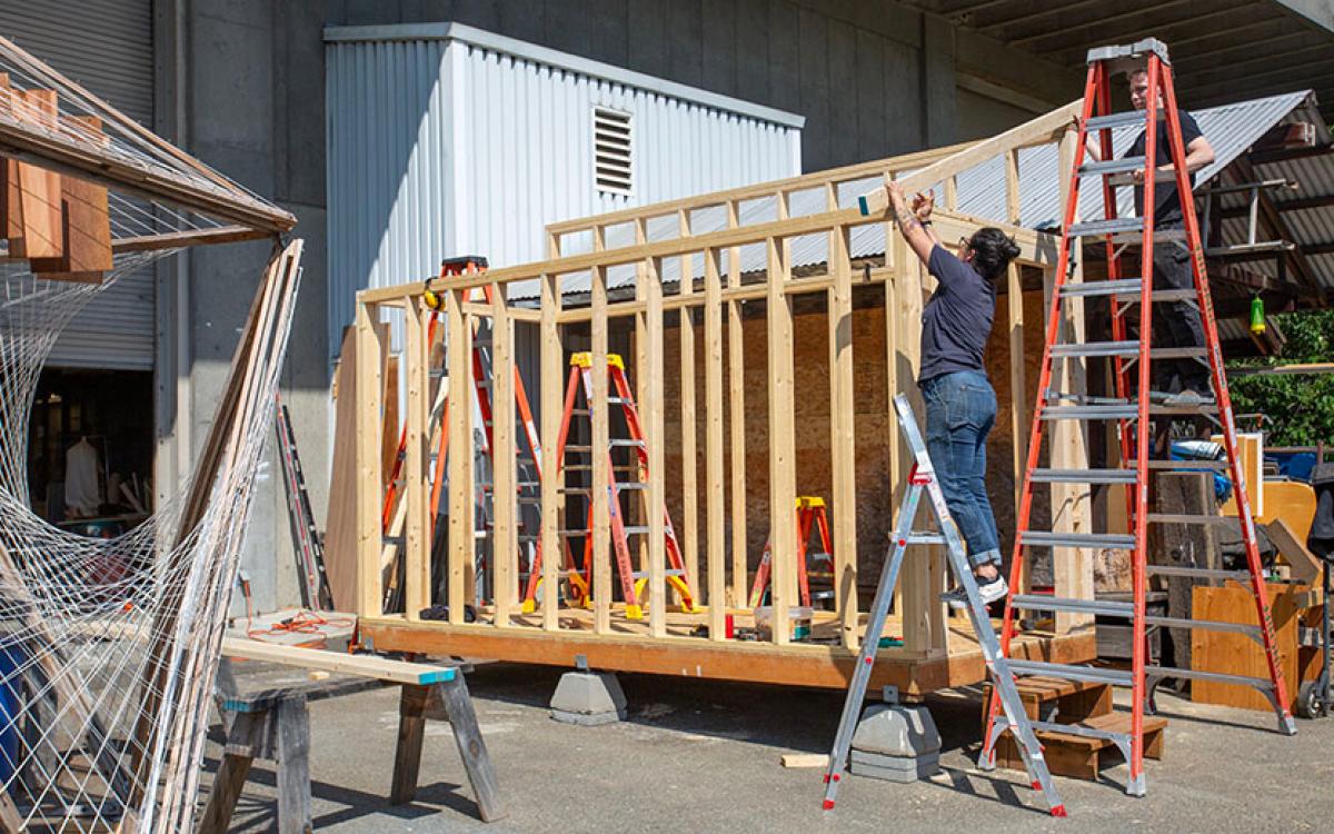 salvage wood storage shed under construction 