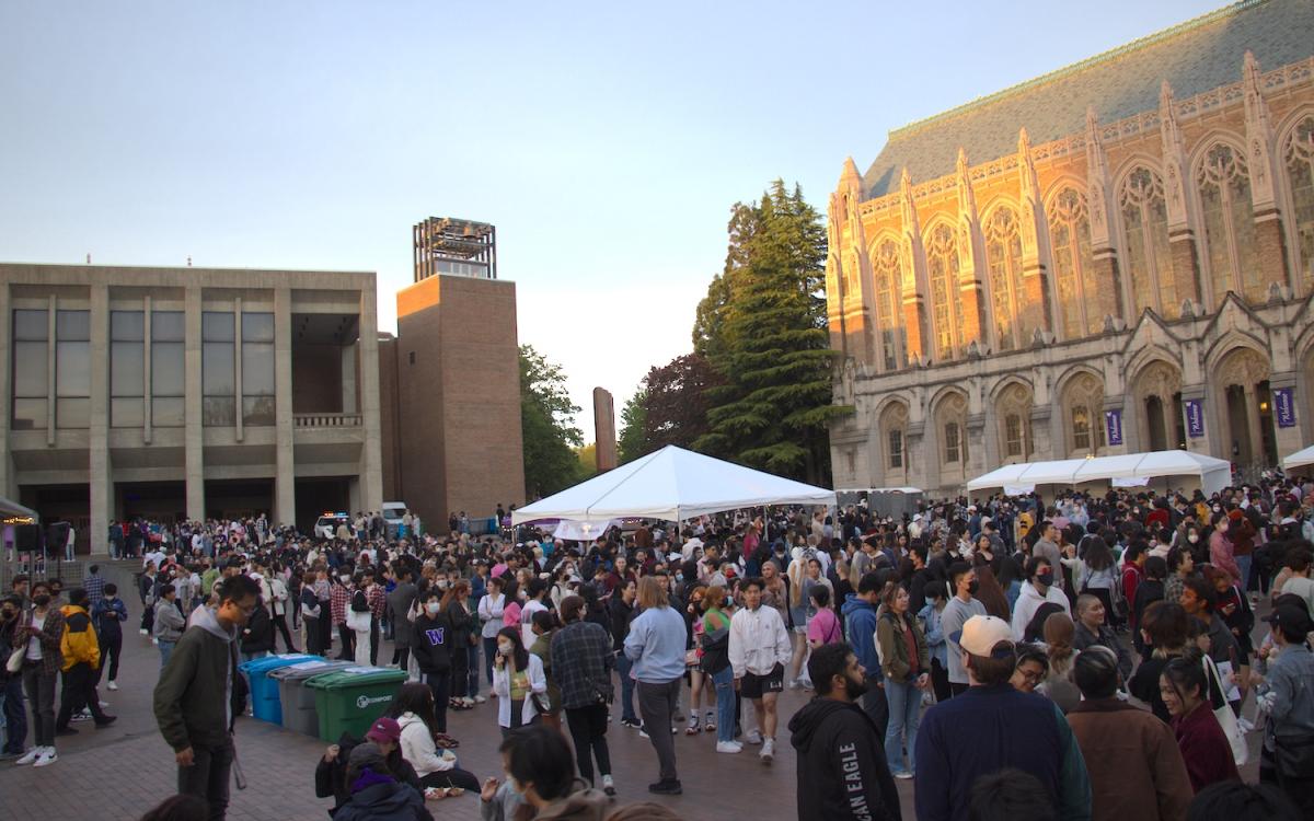 UW red square with lots of people and tents for TSA night market