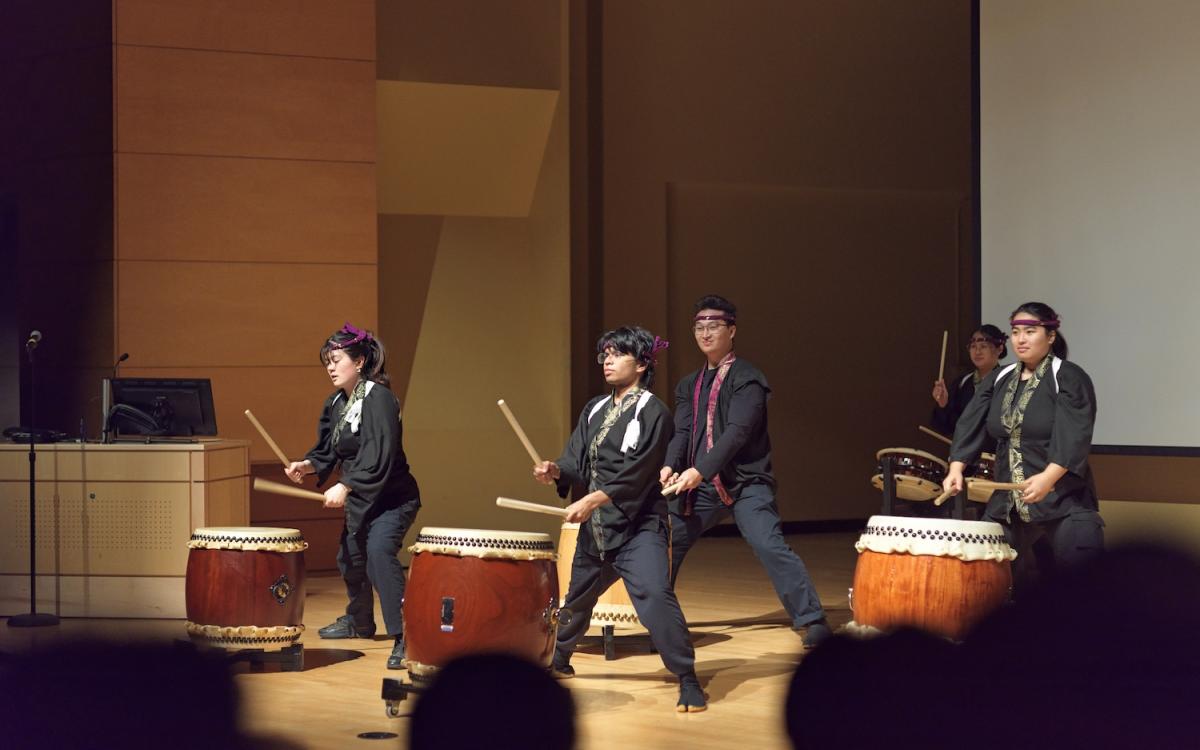 Group of students with large ground drums 