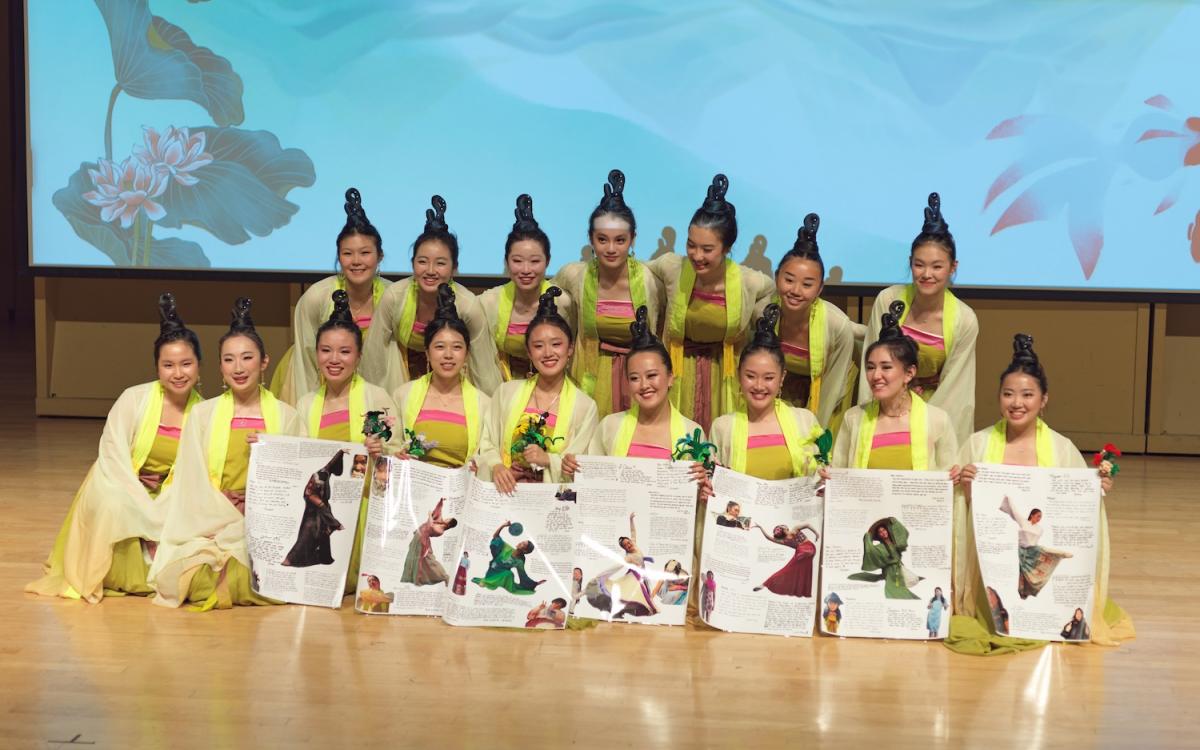 Group of students on stage with traditional wear