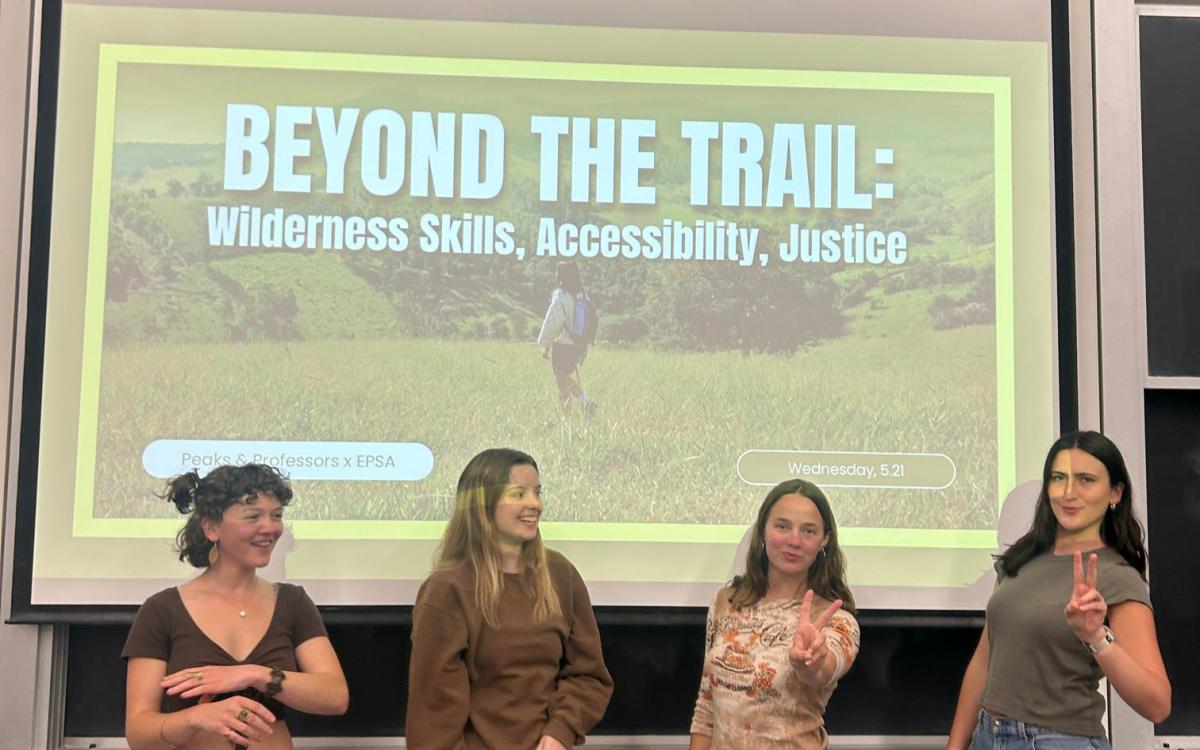 Peaks trip leads in front of a power-point presentation titled "Beyond the Trail: Wilderness Skills, Accessibility, and Justice".