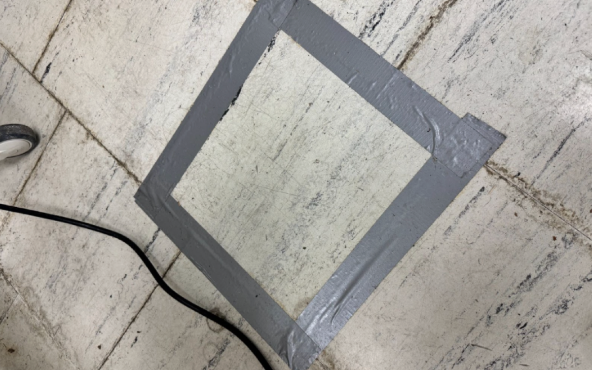 Loose tile taped in place.